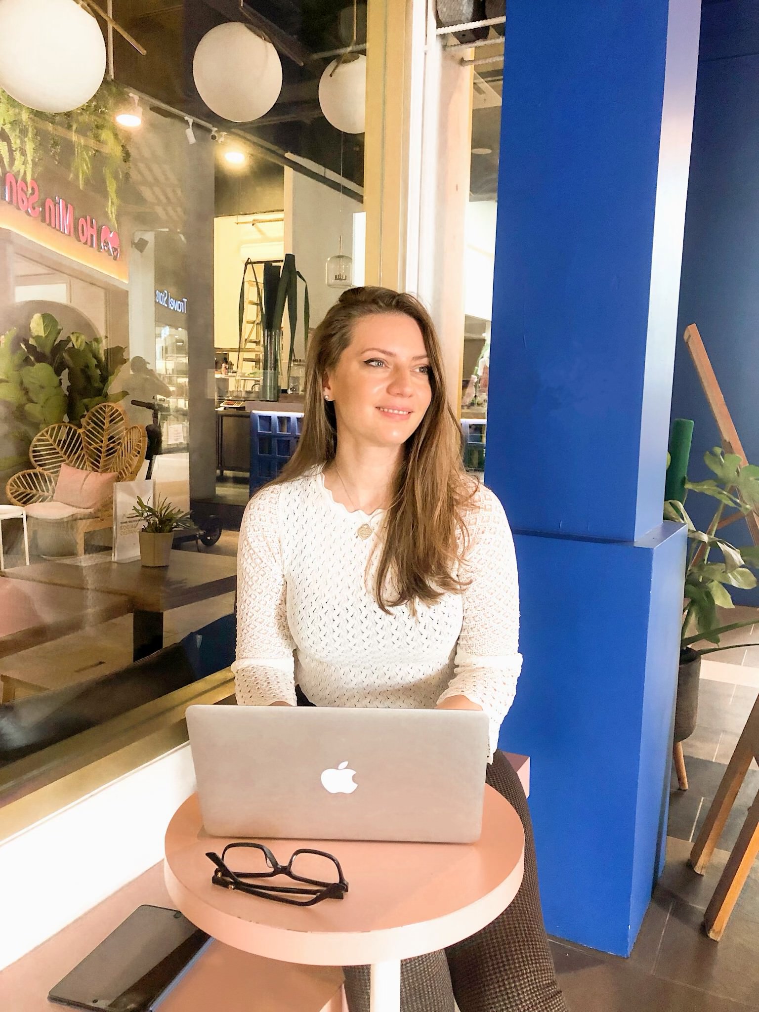 Writer sitting at a table with a laptop