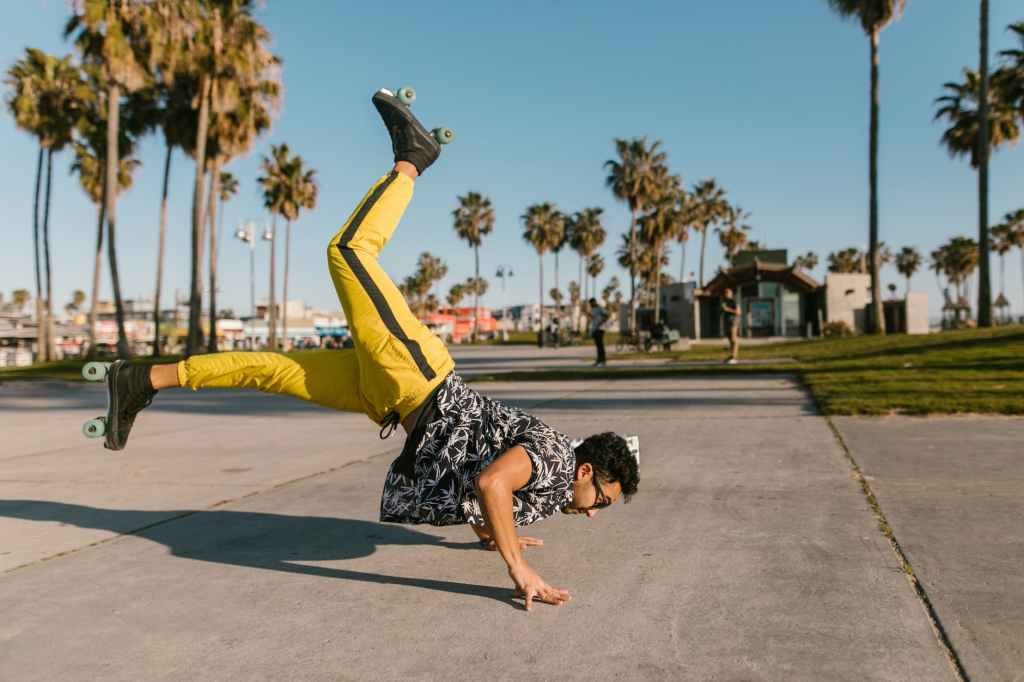a man breakdancing while wearing roller skates