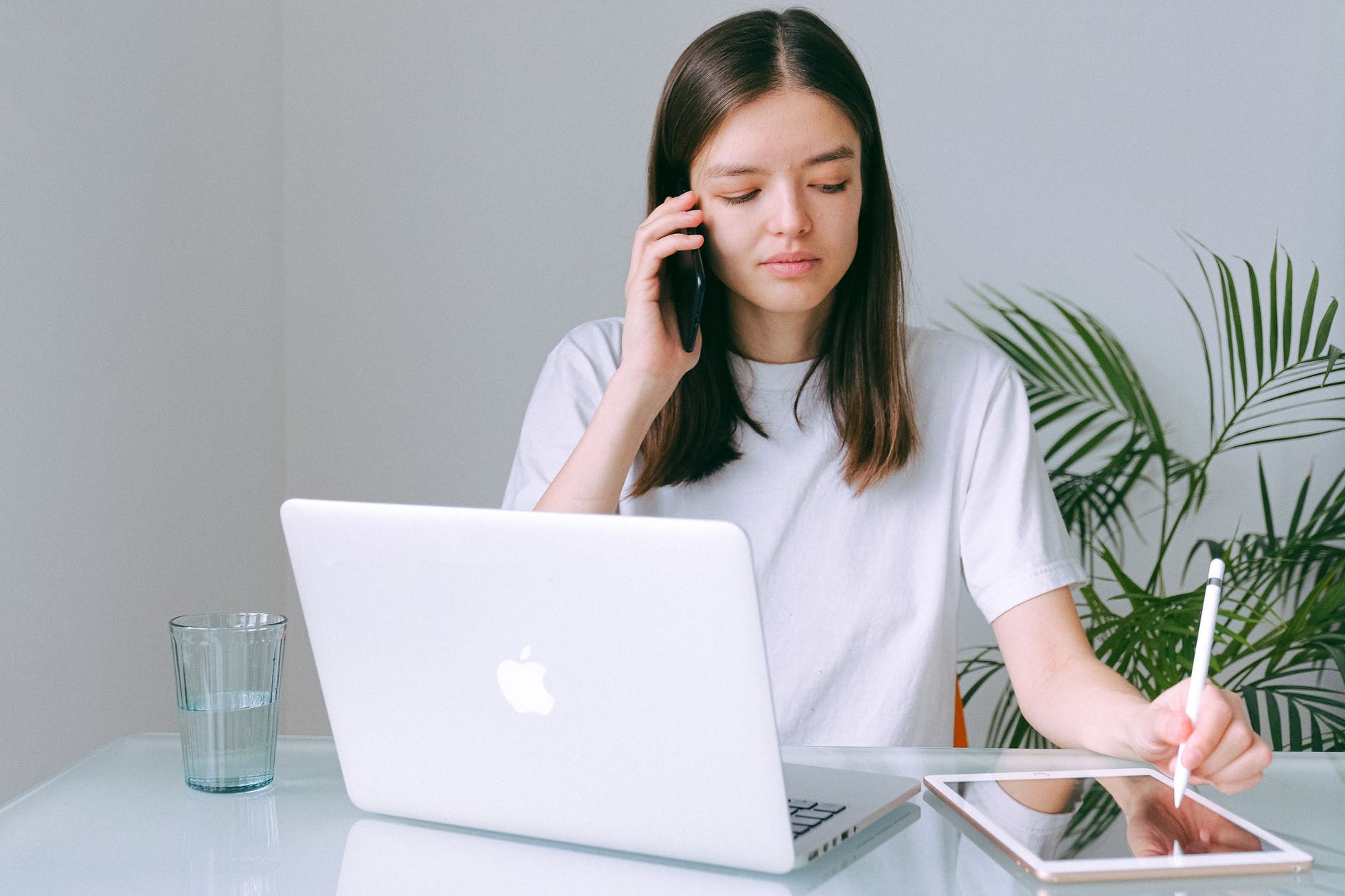 woman in white crew neck t shirt using silver macbook